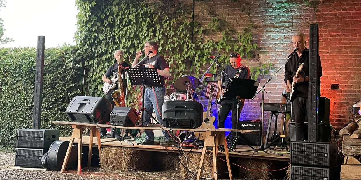 The Vicar and Friends band performing.